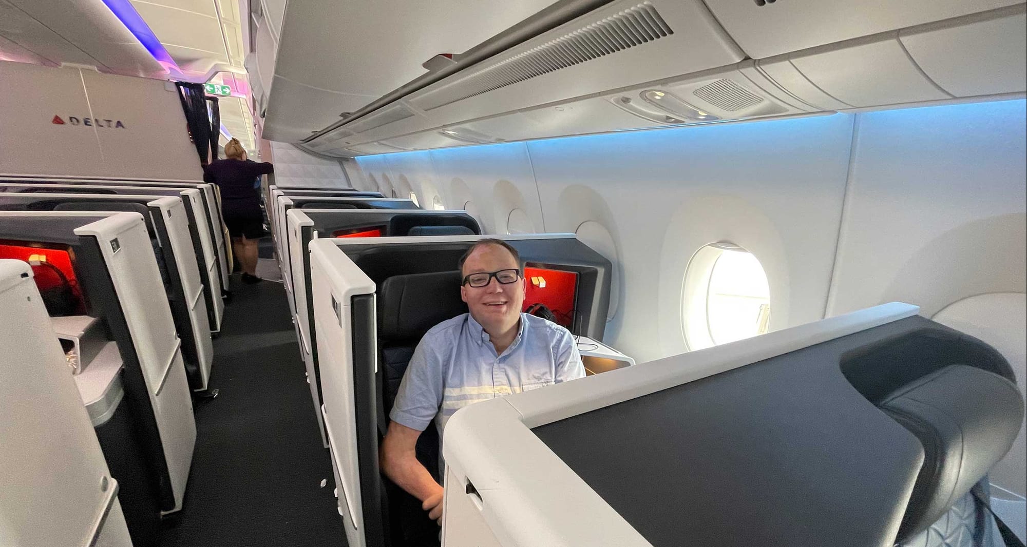 John seated in a seat onboard the airplane.