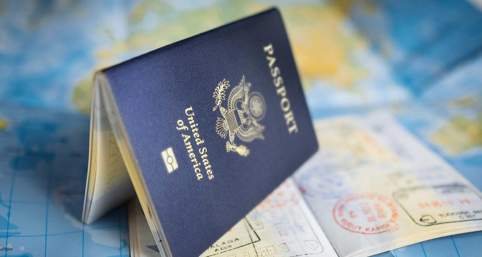 Two passports on a table with a map.