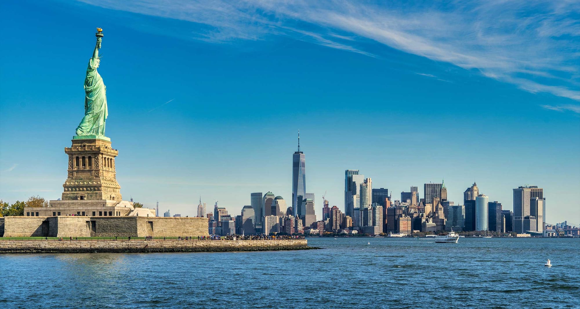 Statue of Liberty in front of New York City skyline.