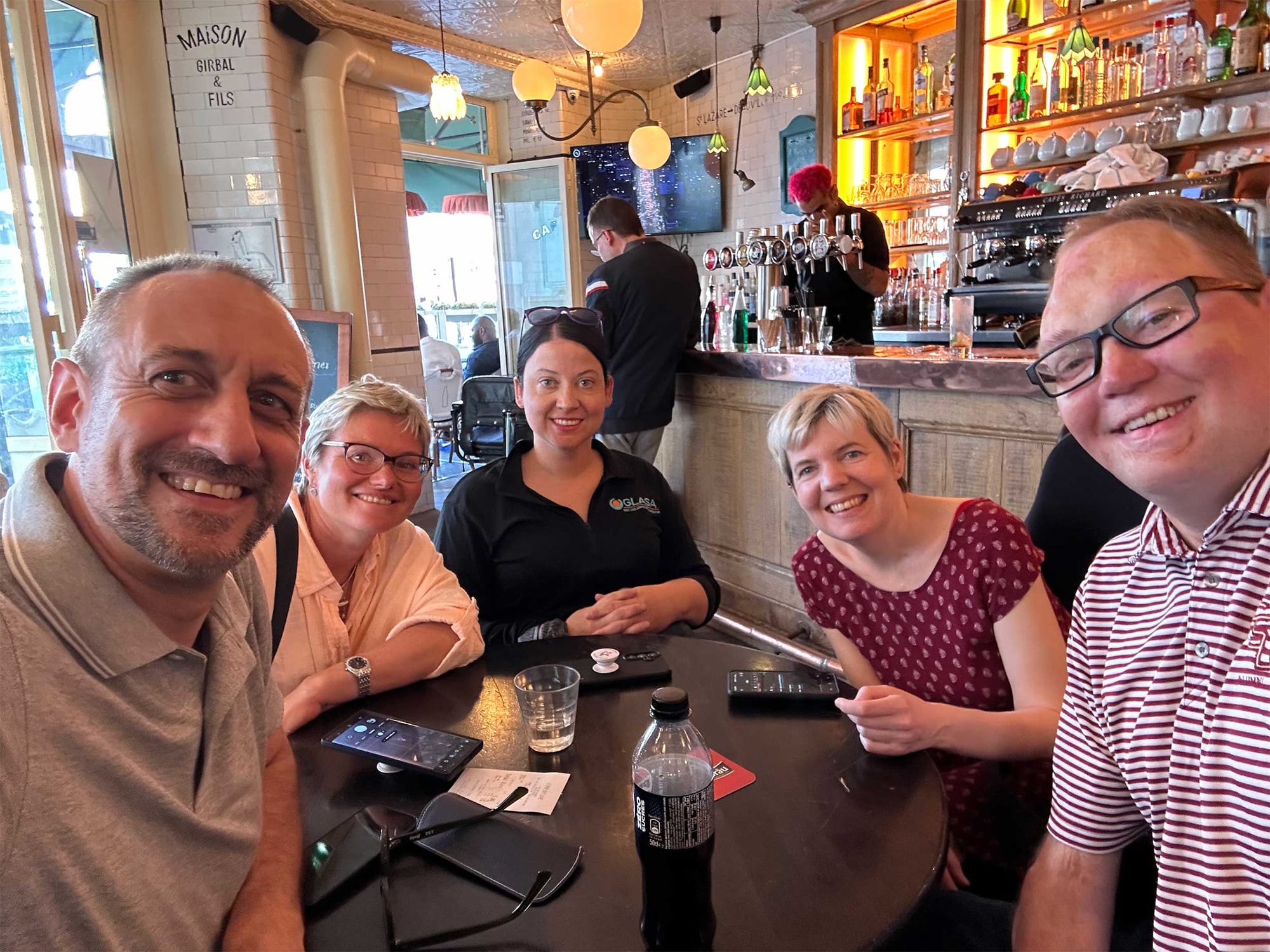 Selfie of John with wheelchair users sitting around a table in a cafe.