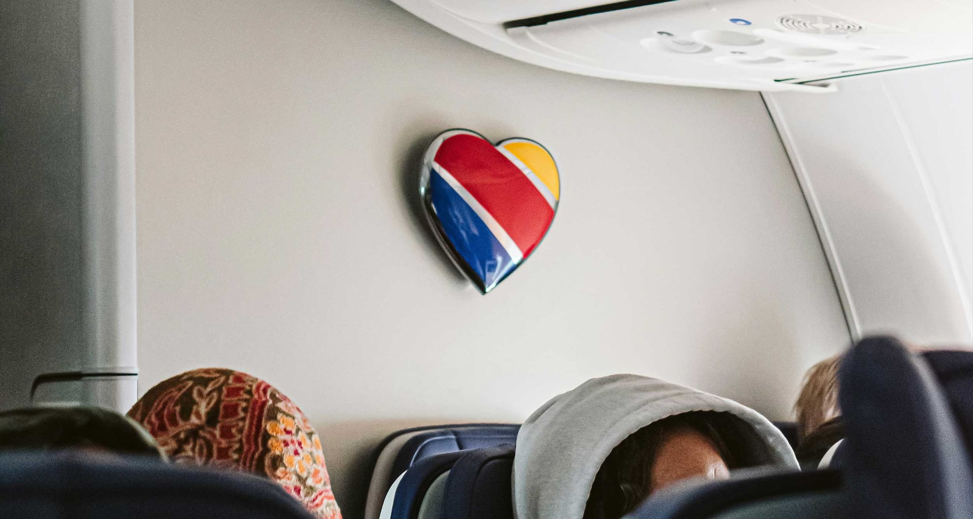 Heart emblem on bulkhead of Southwest Airlines plane cabin.