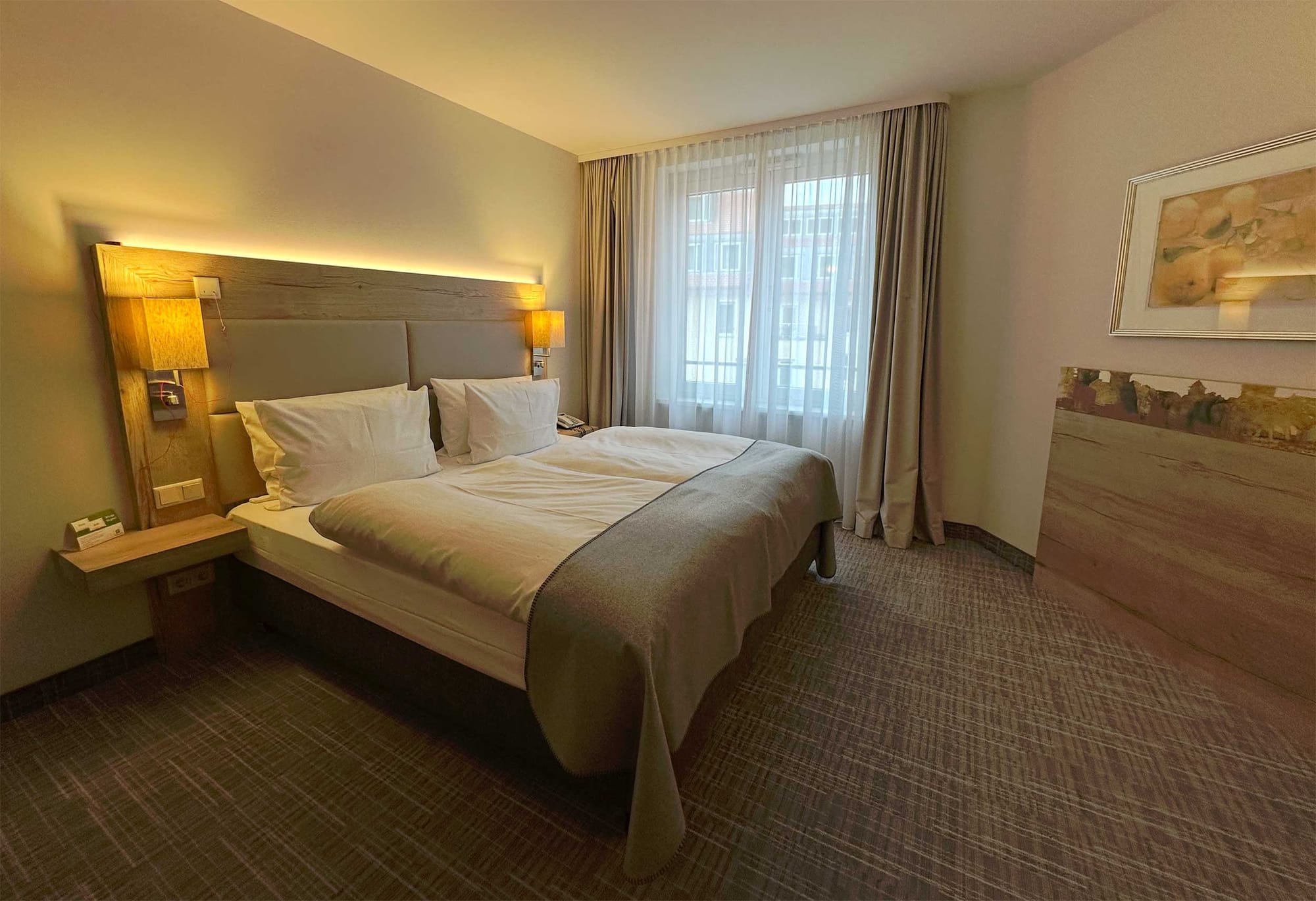 Bed in large, spacious hotel room.