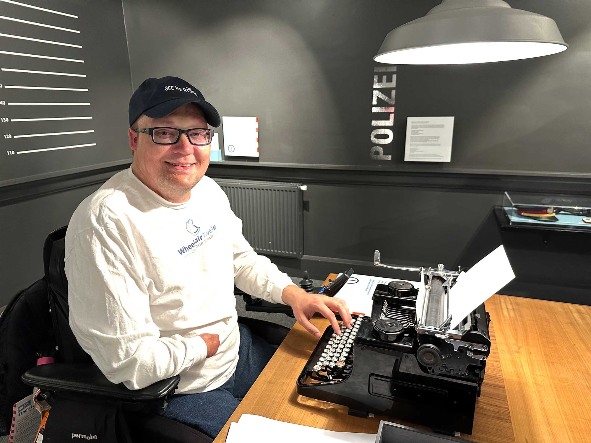 John sitting at a typewriter.