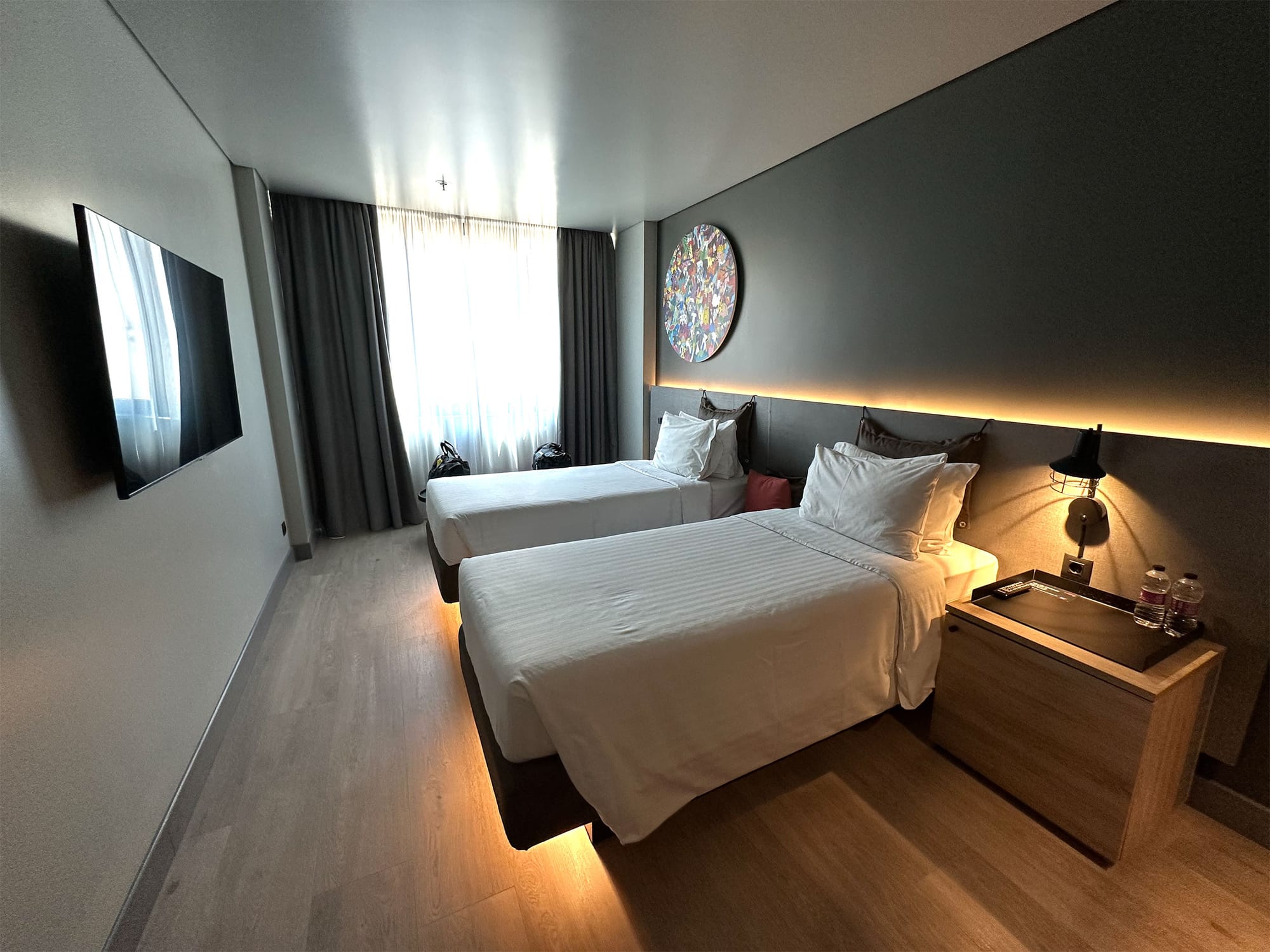 Two twin size beds in a hotel room.