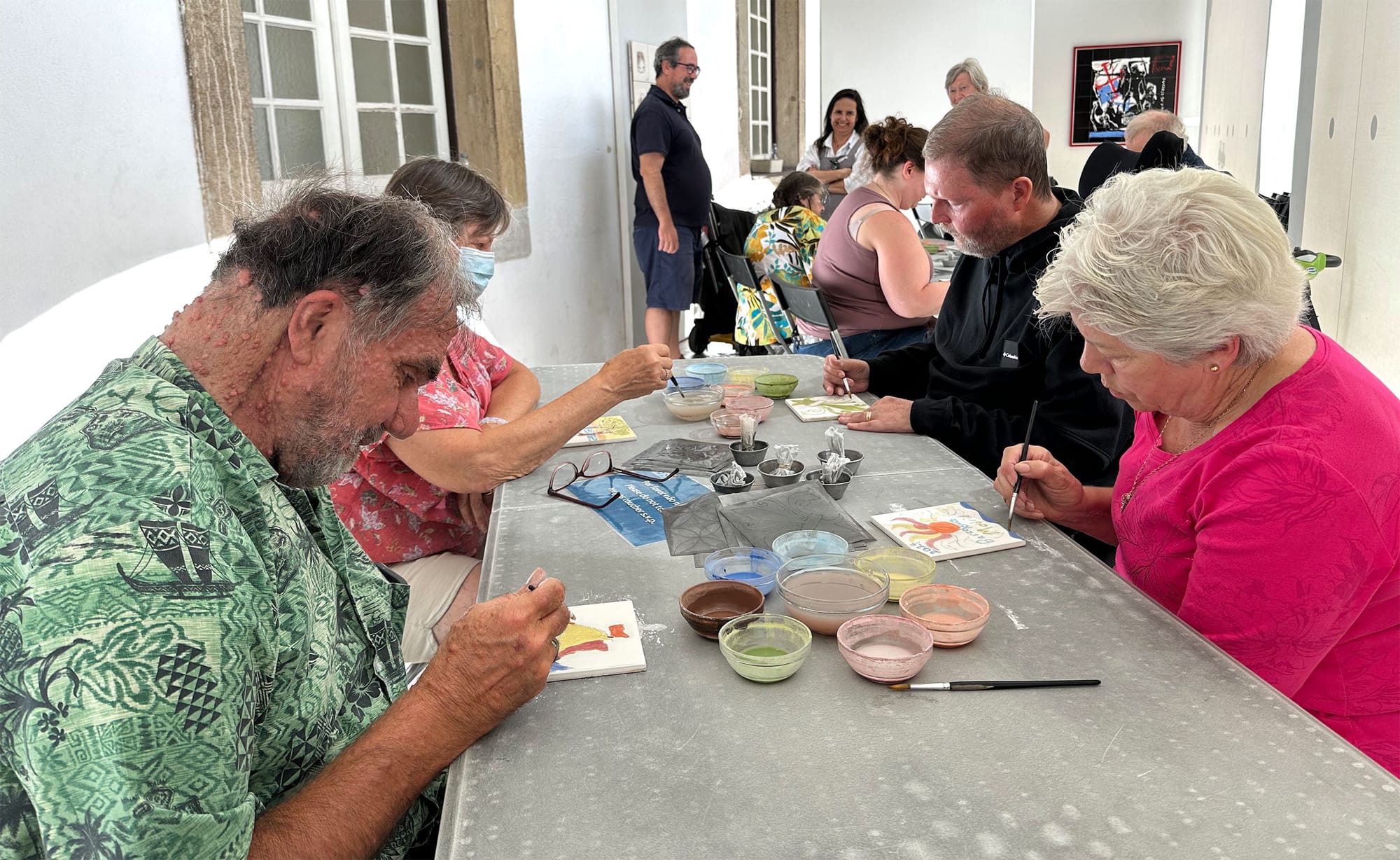 Travelers using watercolors to paint traditional Portuguese tiles.
