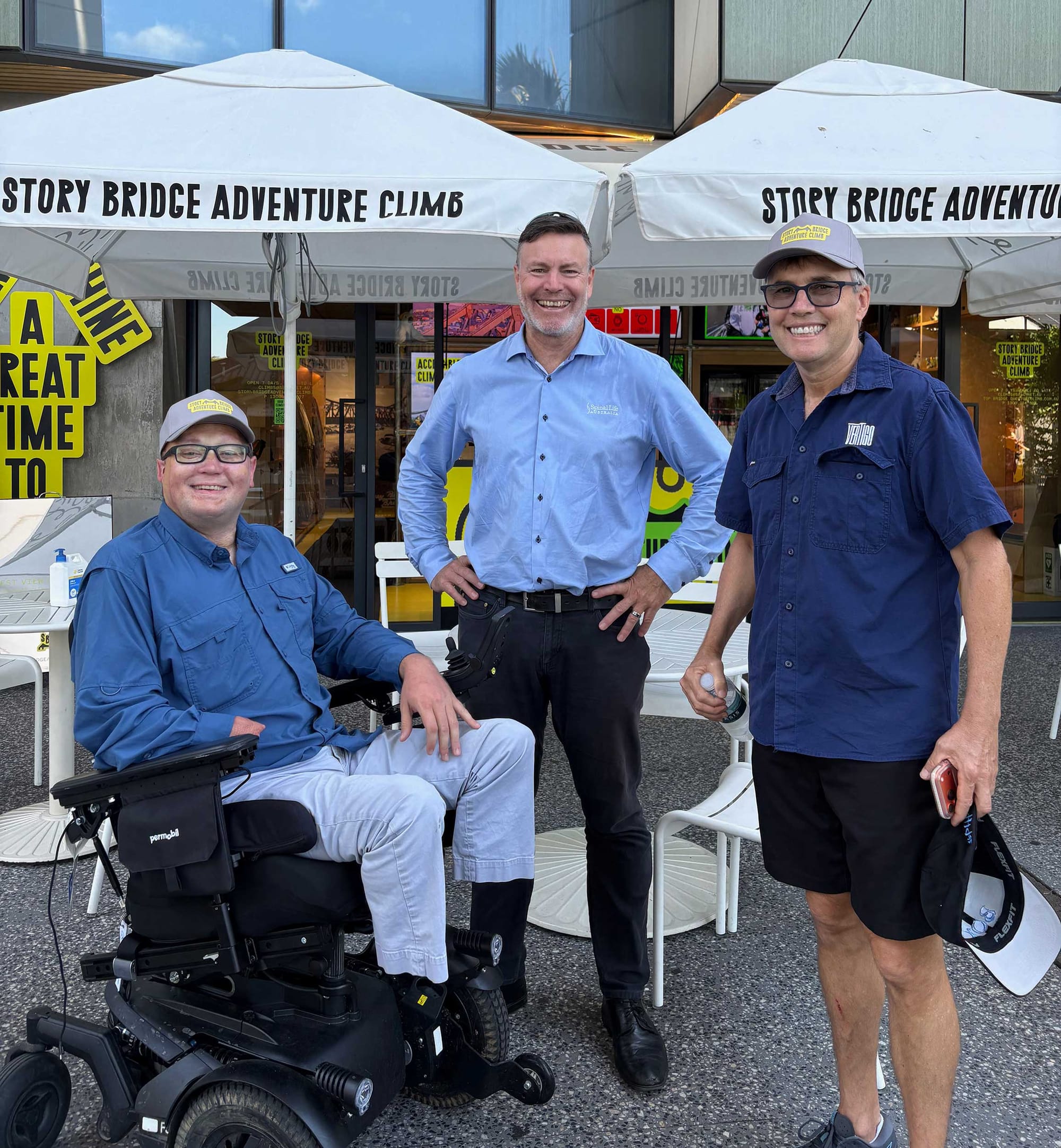 John pictured with two men outside of adventure climb offices.