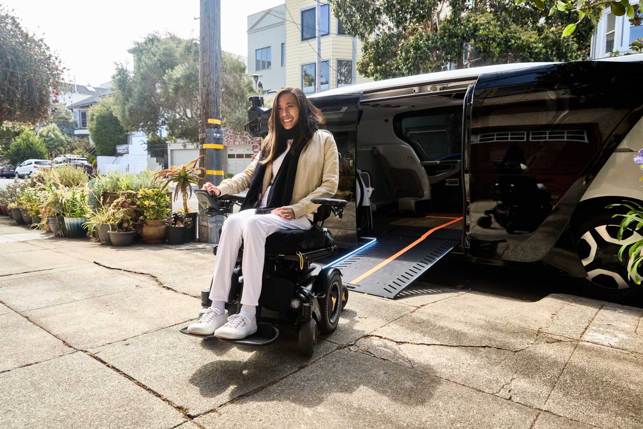 Woman in wheelchair exiting futuristic wheelchair taxi.