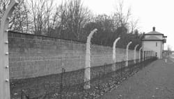 Barbed-wire fence and wall of Sachsenhausen Concentration Camp outside Berlin, Germany.