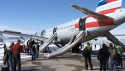 Photo Description: An American Airlines aircraft on a runway at Denver International Airport, with its emergency evacuation s