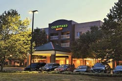 PHOTO DESCRIPTION: Exterior of the Courtyard Edison Woodbridge Hotel during the evening.