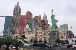 PHOTO DESCRIPTION: Exterior view of the New York-New York Hotel & Casino, with its skyscraper-like tower facade, Statue of Li