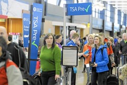 PHOTO DESCRIPTION: Line of passengers at TSA PreCheck airport security checkpoint.