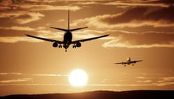 Airplanes against a sunset sky