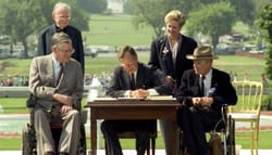 President George H.W. Bush signs with Americans with Disabilities Act into law on July 26, 1990.