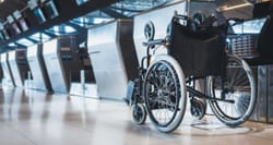 Manual wheelchair at airport check-in counter.