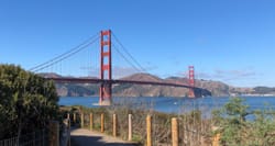 Golden Gate Bridge against a clear blue sky.