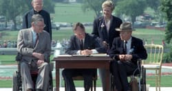 President George H.W. Bush signs the Americans with Disabilities Act into law.