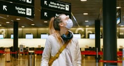 Woman wearing a mask in an airport.