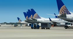 Multiple United Airlines jets parked at airport gates.