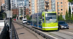 Streetcar rolling amid traffic in Portland, Oregon.