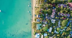 Aerial view of vacation homes along the beach shore.