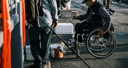 Wheelchair user with a fishing rod.