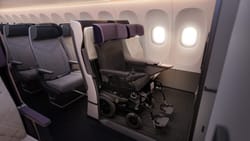 Power wheelchair secured in airplane cabin.