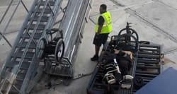 Wheelchair flipping through the air on the airport ramp.