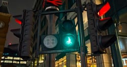 Pedestrian crossing signal with illuminated wheelchair icon.