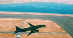 Shadow of an airplane on the ground after takeoff.