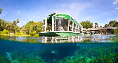 Glass bottom boat on river, with underwater view.