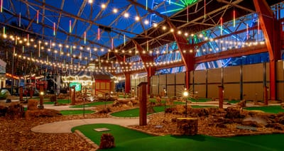 Miniature golf course with a ferris wheel in the background.