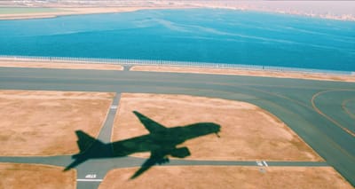 Shadow of an airplane on the ground after takeoff.