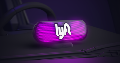 Illuminated Lyft logo sign in dashboard of car.