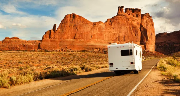 Wheelchair accessible RV driving down road.