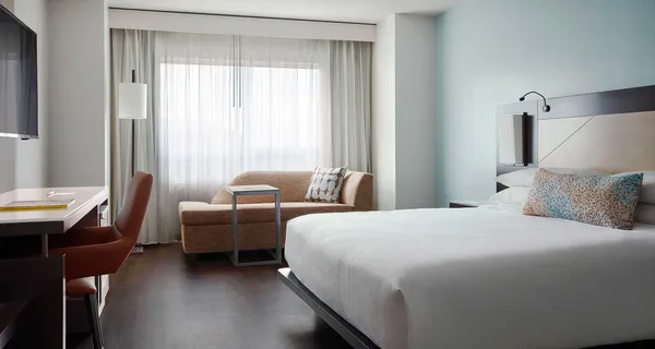 Accessible Orlando hotel room with hard floors and a lowered bed.