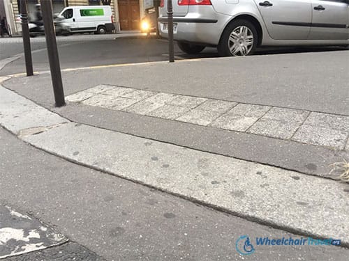 A sidewalk curb cut in Paris, France - Photo by John Morris