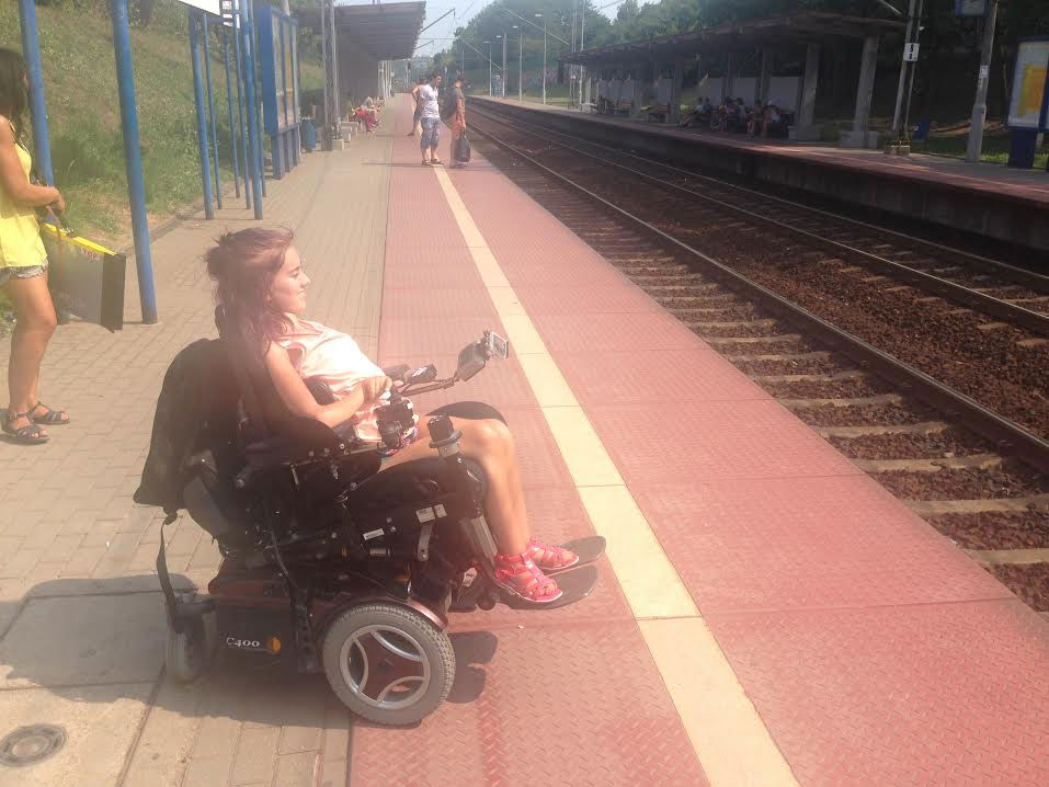 Tonje in her wheelchair at a train station in Warsaw, Poland