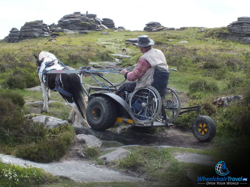 Pony And Wheelchair Carriage Climbing A Rocky Hill In South Downs Way National Park