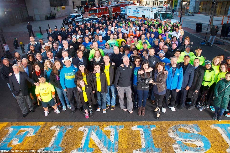 Photo Description: Survivors of the Boston Marathon bombing, gathered at the finish line one year after the attack.