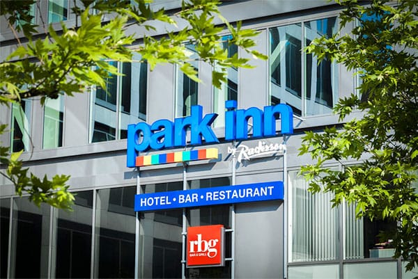 Photo Description: Park Inn by Radisson Brussels Midi, close-up of sign on the outside of the hotel building.