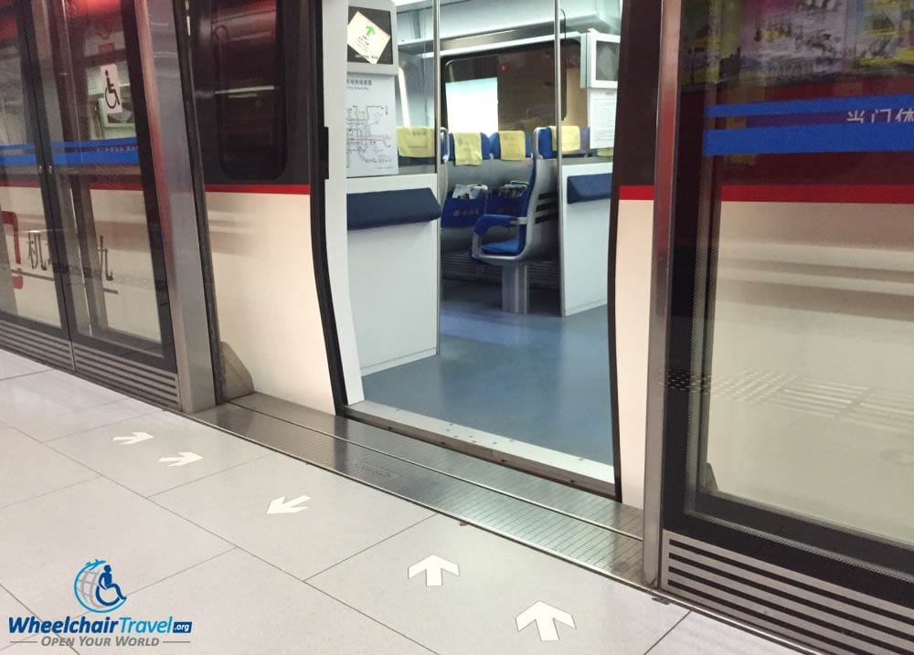 PHOTO DESCRIPTION: The barrier-free entrance to the Beijing Airport Express Train at the airport. Train doors are open and the minimal gap between train and platform is shown.