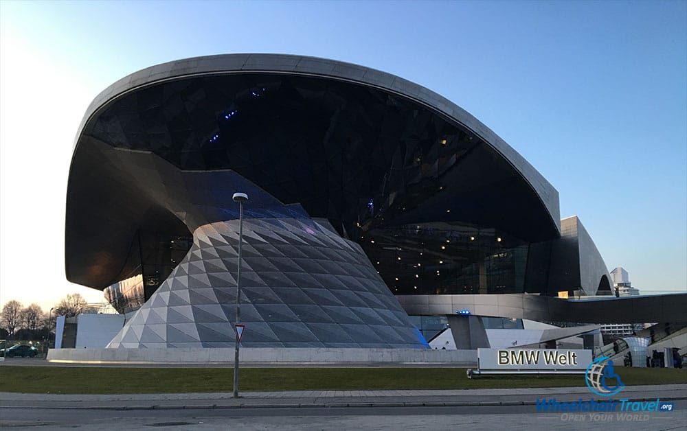 PHOTO DESCRIPTION: External view of the BMW Welt building, with a sweeping and curved rooftop and facade.