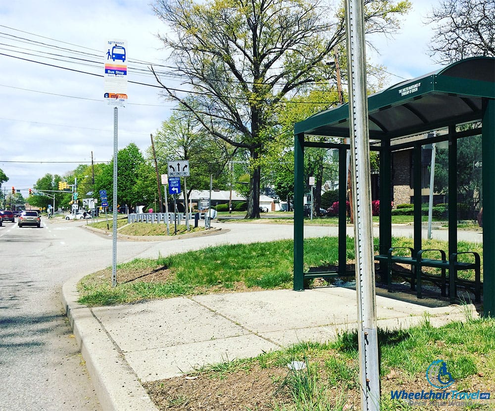 PHOTO DESCRIPTION: Bus stop with no curb cut,.