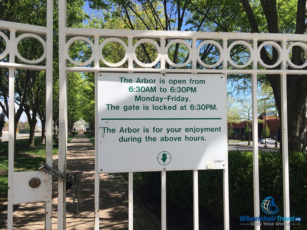 PHOTO DESCRIPTION: A sign affixed to a locked gate reads, 'The Arbor is open from 6:30 a.m. to 6:30 p.m. Monday-Friday. The gate is locked at 6:30 p.m. -- The Arbor is for your enjoyment during the above hours.'