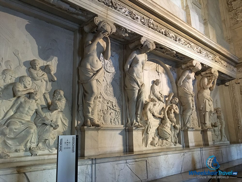 PHOTO DESCRIPTION: Four statue carvings laid into a wall, in what was the Town Hall's Tribunal.