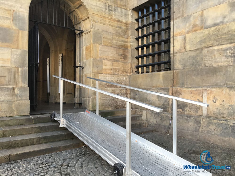 PHOTO DESCRIPTION: A metal, wheelchair accessible ramp leading to the entrance of the Royal Palace of Amsterdam.