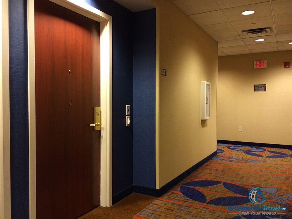 PHOTO DESCRIPTION: View of the hotel hallway and the door to room #115 at the Courtyard Marriott Edison Woodbridge.