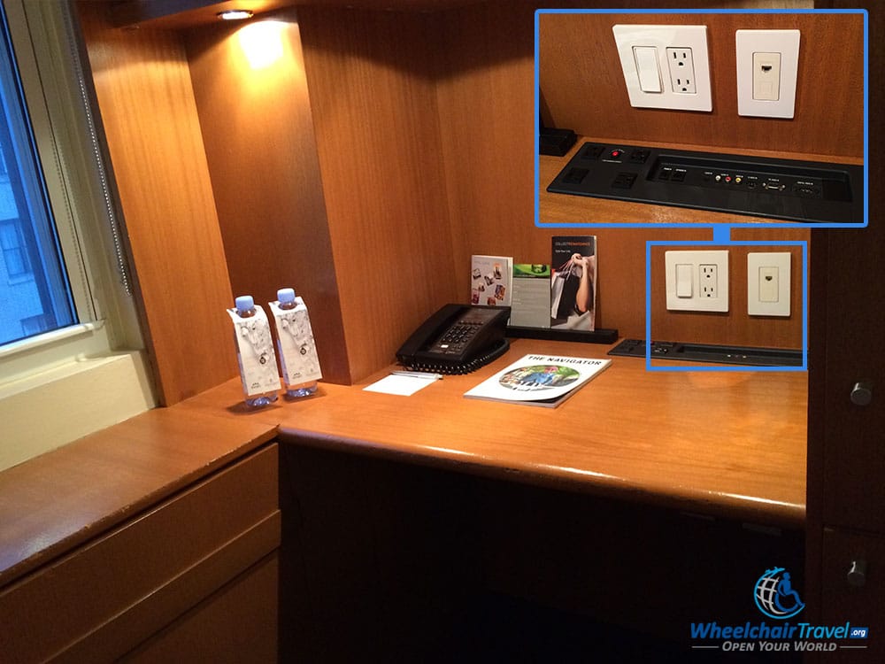 PHOTO DESCRIPTION: A desk built-in to a cabinet space, with numerous power outlets and connections.