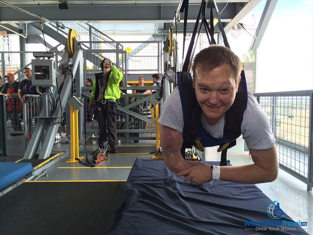 PHOTO DESCRIPTION: John Morris hanging from the zip line on the ZlotZilla Zoomline.